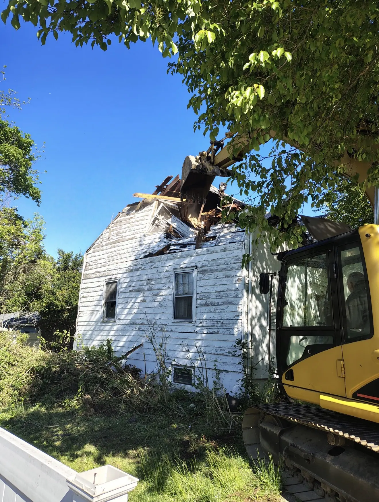 Excavator at a residential demolition jobsite
