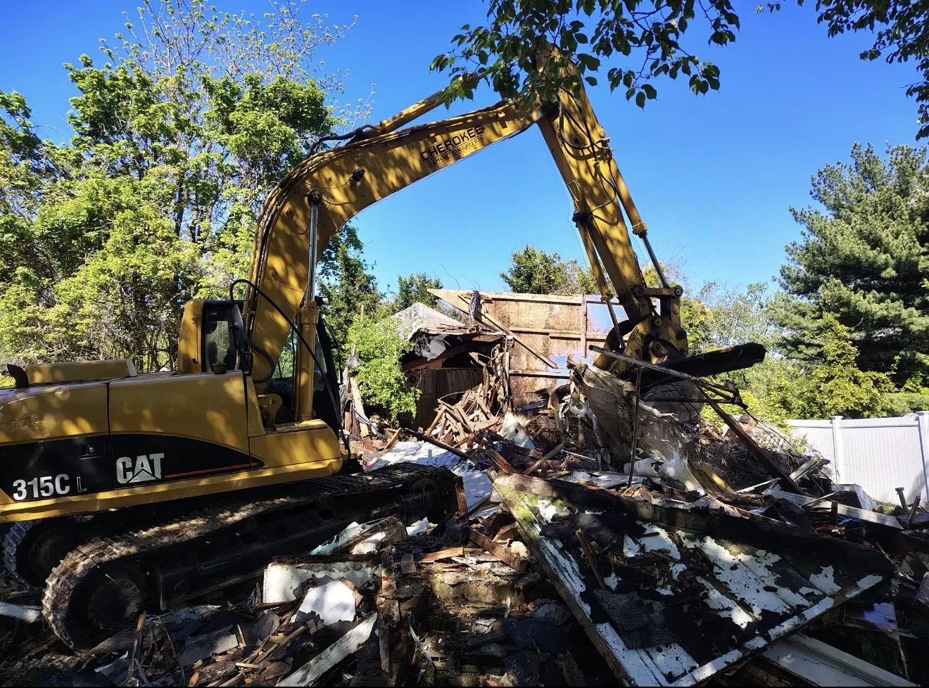 Excavator loading demolition debris for haul-away