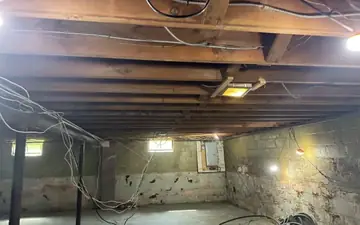 Home interior stripped to the studs and ceiling joists during demolition